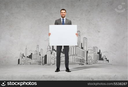 business, education, office and advertising concept - smiling businessman with big white blank board