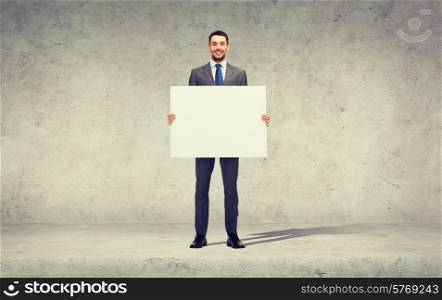 business, education, office and advertising concept - smiling businessman with big white blank board