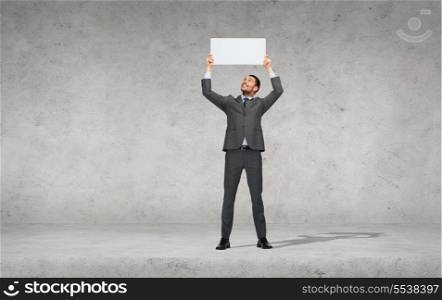business, education, office and advertising concept - smiling businessman with small white blank board
