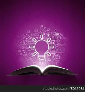 Business education. Old opened book with business sketches over purple background