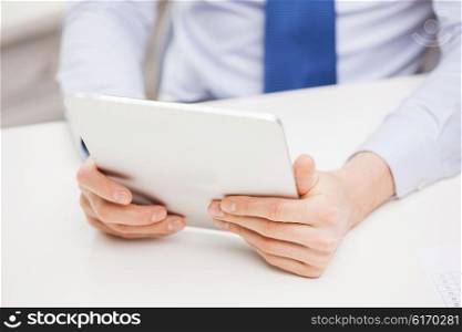 business, education, people and technology concept - close up of businessman with tablet pc in office