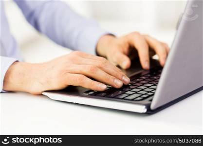 business, education, people and technology concept - close up of male hands with laptop on table typing. close up of male hands with laptop typing