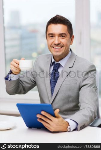 business, education, people and technology concept - smiling businessman with tablet pc computer and coffee in office