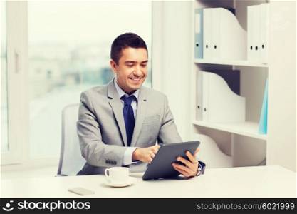 business, education, people and technology concept - smiling businessman with tablet pc computer and coffee in office