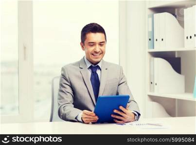 business, education, people and technology concept - smiling businessman with tablet pc computer in office