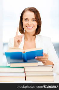 business, education, school, documents, people concept - smiling businesswoman or student with stack pile of books