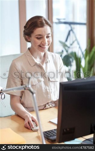 business, education, startup and people concept - happy woman or student with computer at office