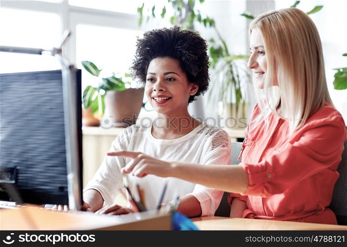 business, education, startup and people concept - happy women or students with computer in office