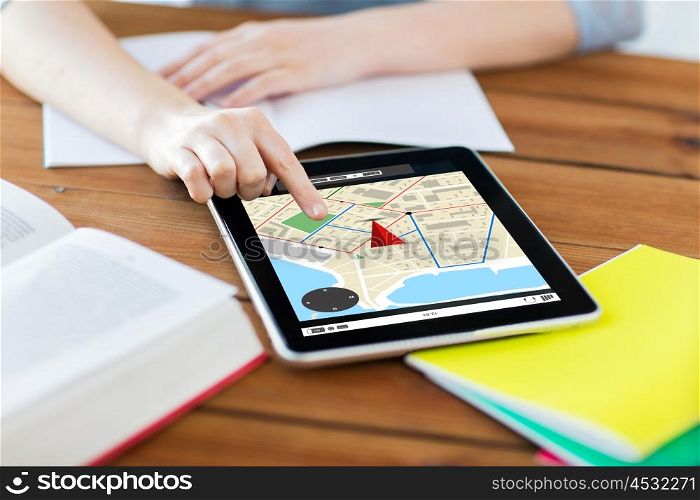 business, education, technology and location concept - close up of student woman with gps navigator map on tablet pc computer screen and notebook at home with gps navigator map on screen