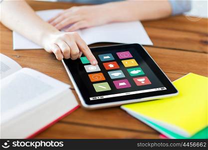 business, education, technology and multimedia concept - close up of student woman with menu icons on tablet pc computer screen and notebook at home