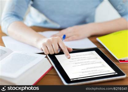 business, education, technology and people concept - close up of student woman with coding on tablet pc computer and notebook at home