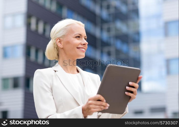 business, education, technology and people concept - smiling businesswoman working with tablet pc computer on city street