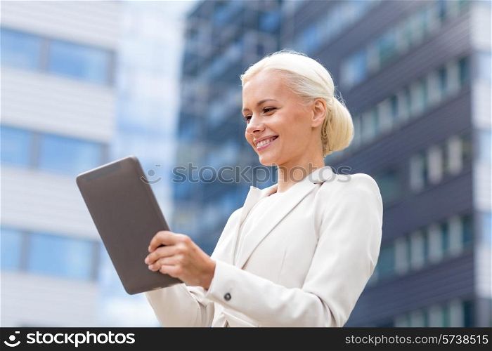 business, education, technology and people concept - smiling businesswoman working with tablet pc computer on city street