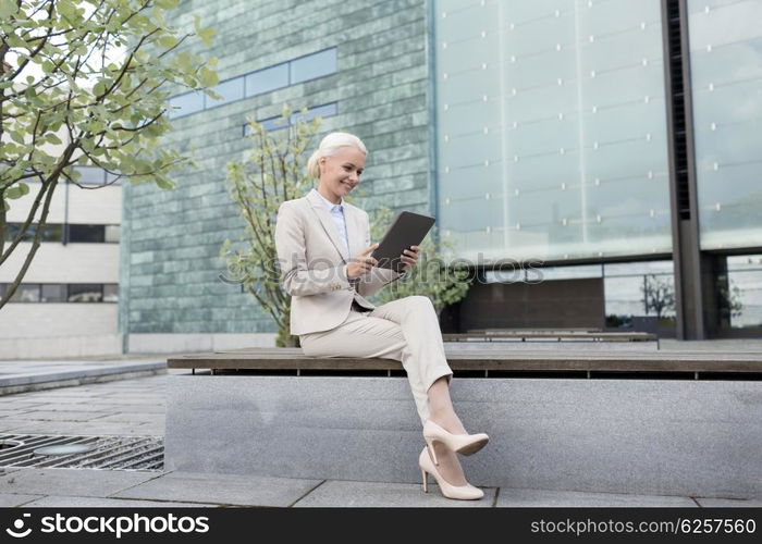 business, education, technology and people concept - smiling businesswoman working with tablet pc computer on city street