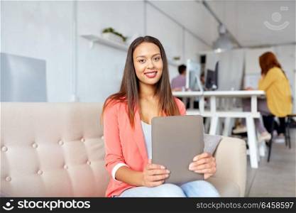 business, education, technology and people concept - young african american woman with tablet pc computer working at office. african american woman with tablet pc at office