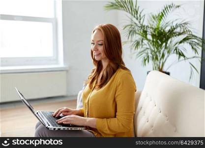 business, education, technology and people concept - young woman with laptop computer working at office. woman with laptop working at office