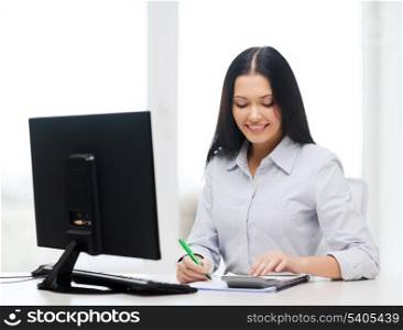 business, education, technology and tax concept - smiling businesswoman or student with coputer, calculator, notebook and pen