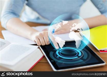 business, education, technology, people and internet concept - close up of student woman with earth globe on tablet pc computer and notebook at home