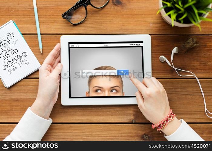 business, education, technology, people and internet concept - close up of woman with internet browser search bar on tablet pc computer screen on wooden table