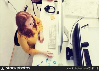 business, education, technology, people and internet concept - smiling creative woman or student with computer at office. smiling businesswoman or student with computer