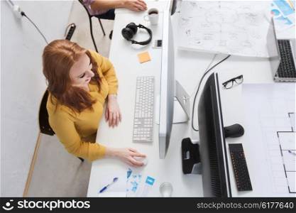 business, education, technology, people and internet concept - smiling creative woman or student with computer at office
