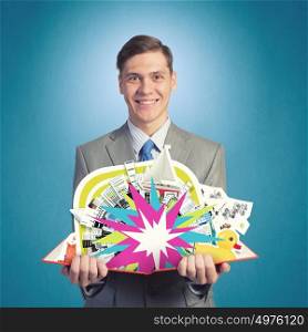 Business education. Young smiling businessman with opend book in hands