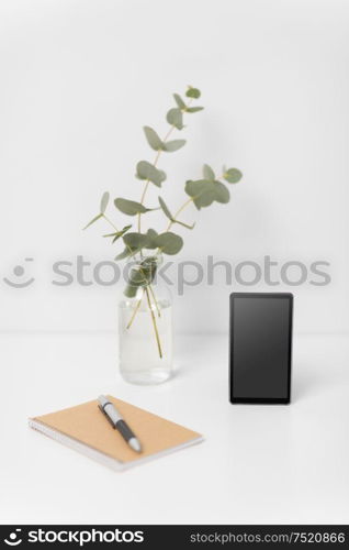 business, electronics and interior concept - smartphone with black screen on white office table. smartphone with black screen on white office table