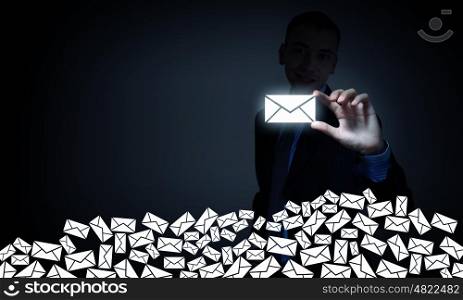 Business email concept. Close view of businessman taking email sign with fingers