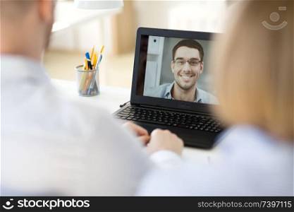 business, employment and technology concept - team of employers having video conference or job interview with new employee at office. business team having video conference at office
