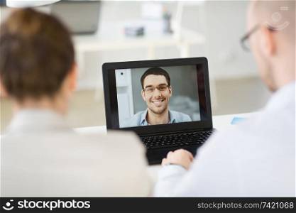 business, employment and technology concept - team of employers having video conference or job interview with new employee at office. business team having video conference at office