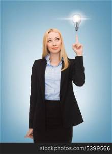 business, energy and environment concept - woman pointing at light bulb