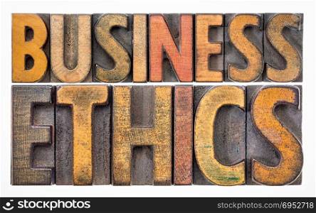 business ethics - isolated text in letterpress wood type printing blocks stained by color inks