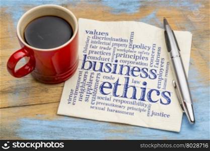 business ethics word cloud - handwriting on a napkin with cup of coffee