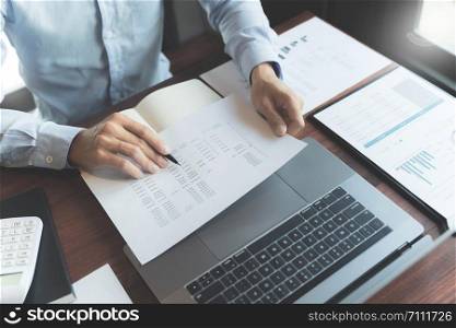 Business executive calculating a sales data perform spreadsheets.