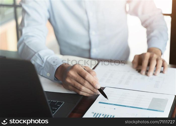 Business executive calculating a sales data perform spreadsheets.