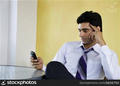 Business executive holding a cell phone