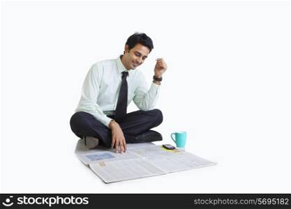 Business executive looking at a newspaper