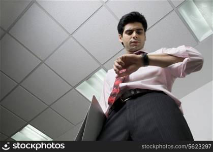 Business executive looking at his watch