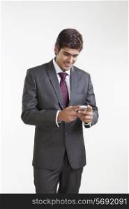 Business executive reading an sms on a mobile phone