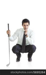 Business executive with a golf club thinking