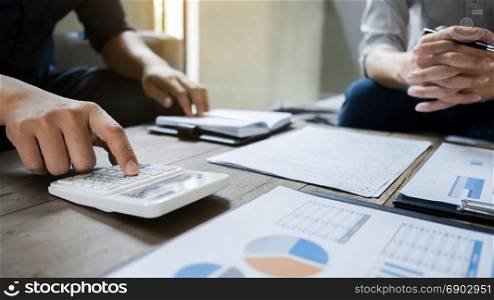 Business executives analyzing on valuation data paper with calculator