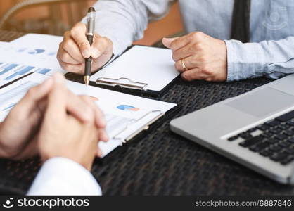 Business Executives discussing about sales performance at a modern outdoor workplace.