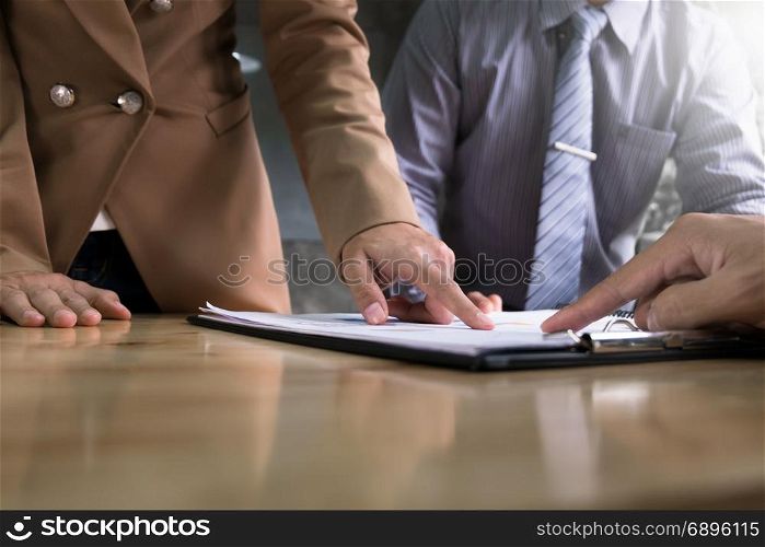 business executives discussing documents and ideas at meeting in a modern office