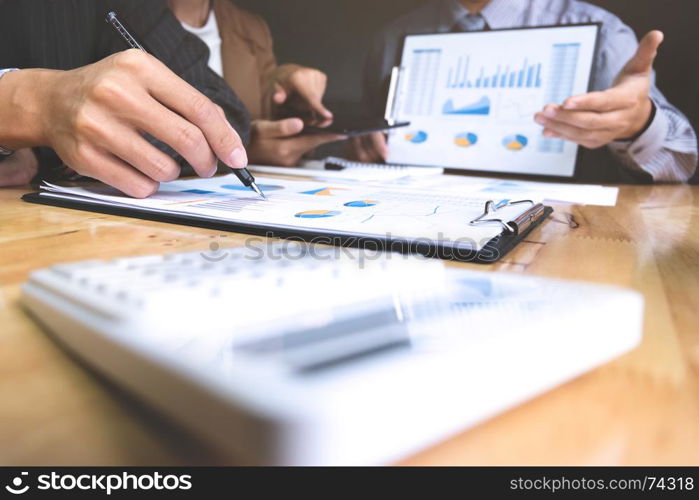 business executives discussing documents and ideas at meeting in a workplace