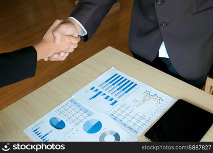 Business executives handshaking agreement project deal at a office