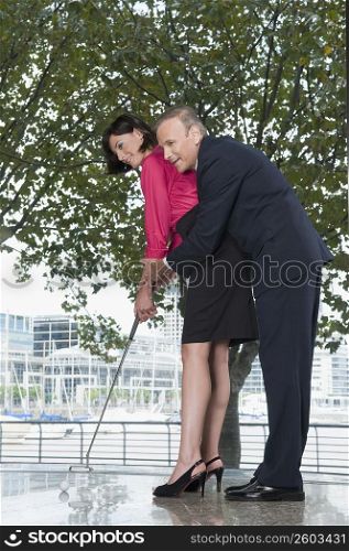 business executives playing golf in an office