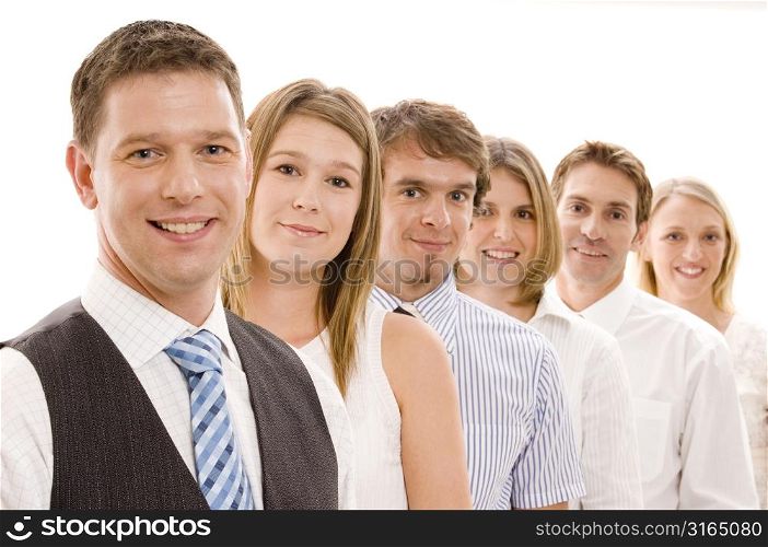 Business executives standing in a row and smiling