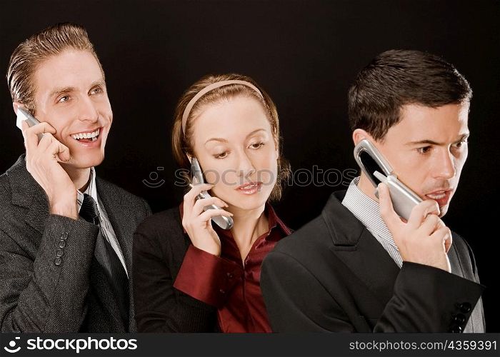 Business executives talking on mobile phones