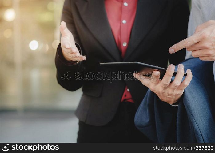 Business executives Using Digital Tablet Outside Office