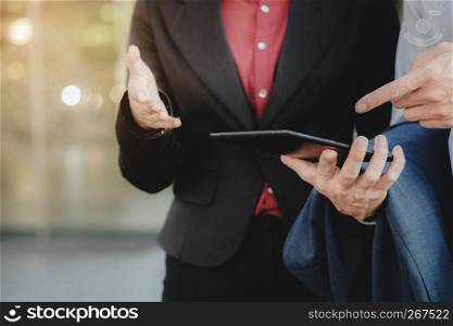 Business executives Using Digital Tablet Outside Office